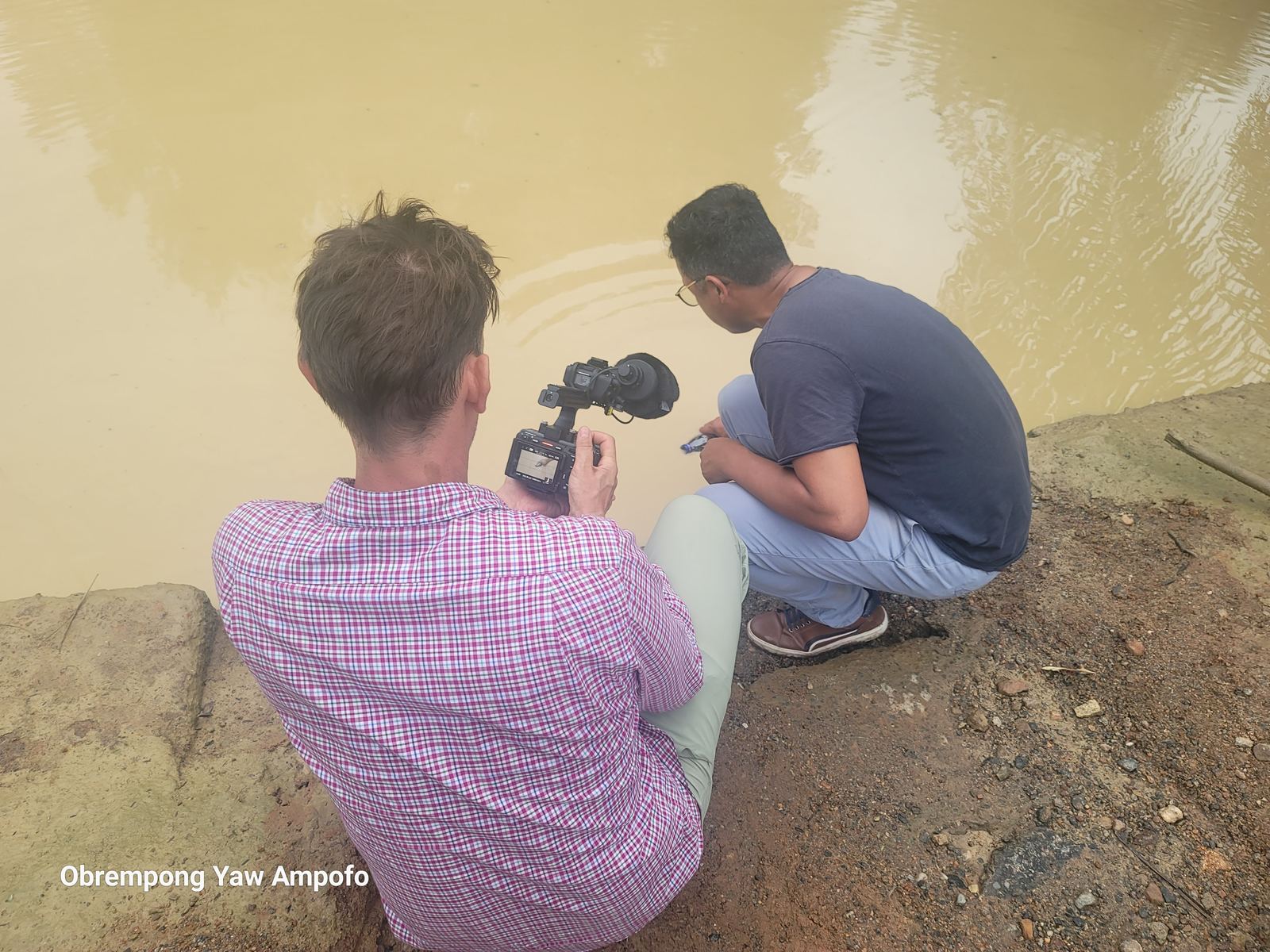 Water sampling on the Whin River near a mining area